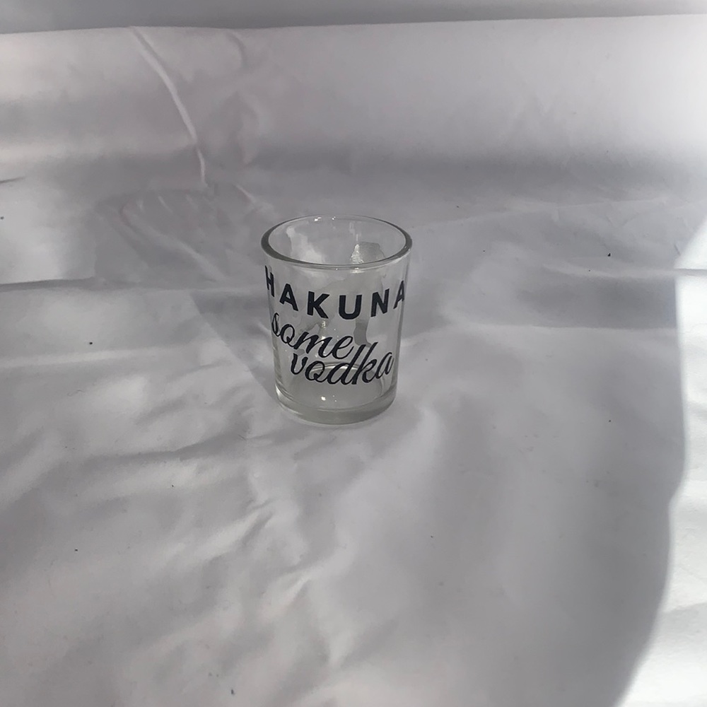 Shot glass saying, “Hakuna some vodka” with lion on back in sparkly letters.
